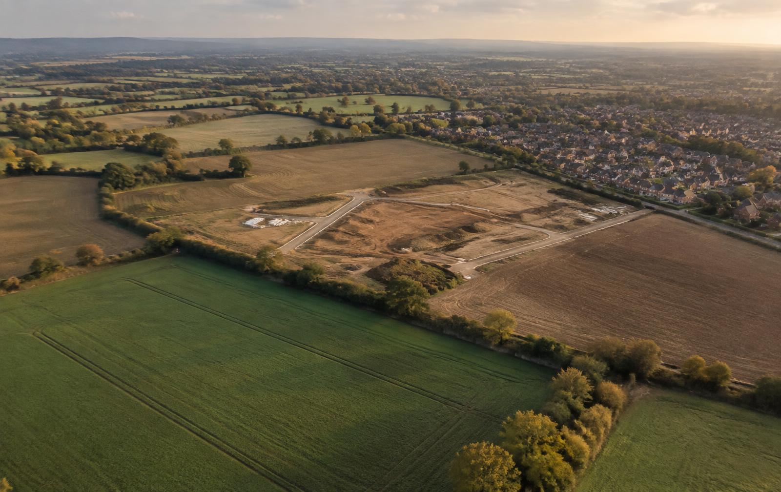 Aerial view of land plots on the edge of a town